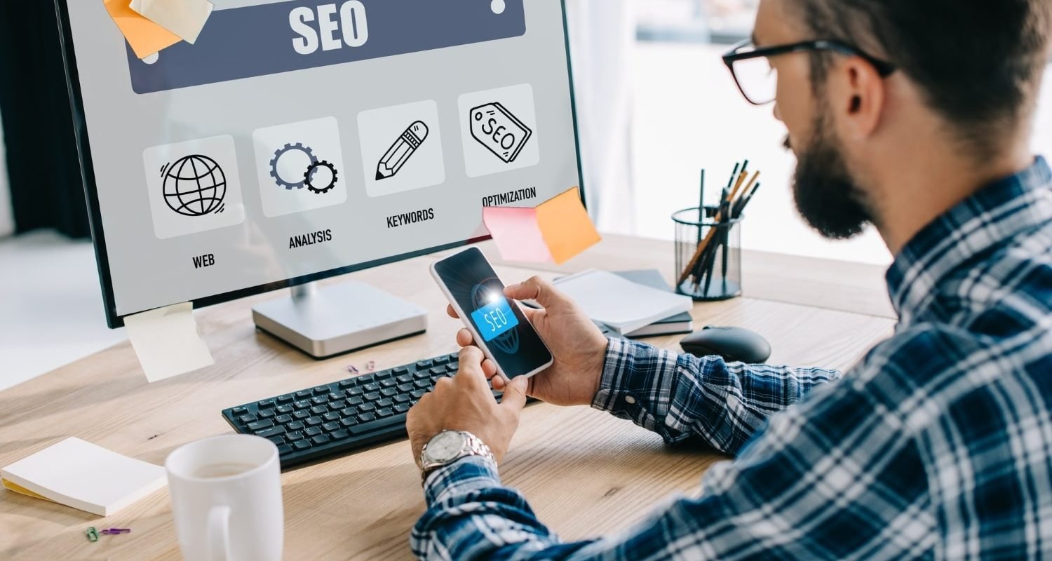 handsome-young-seo-manager-using-smartphone-and-computer-at-workplace-min.jpg handsome-young-seo-manager-using-smartphone-and-computer-at-workplace-min.jpg